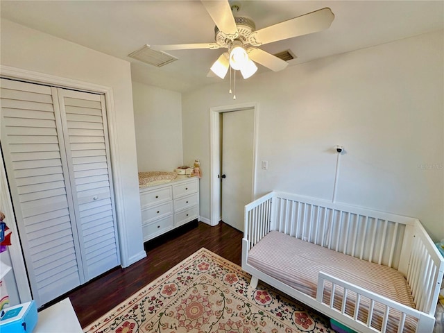 bedroom with ceiling fan, a closet, and dark wood-type flooring