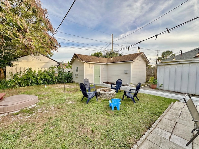 view of yard with a fire pit and an outdoor structure