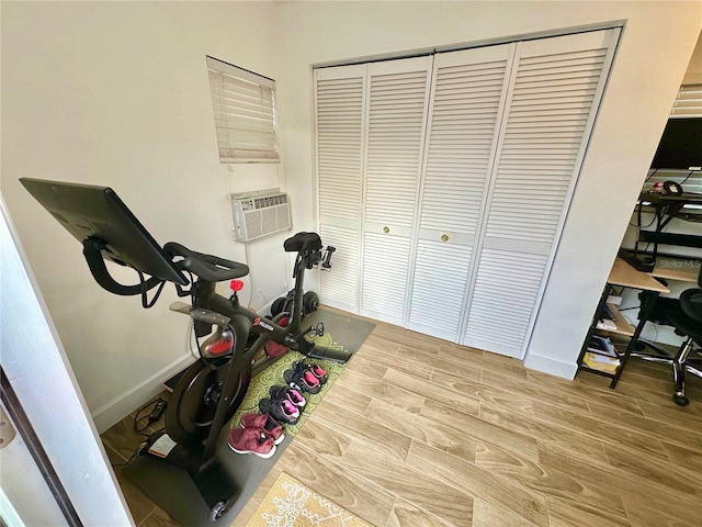 exercise area featuring cooling unit and wood-type flooring