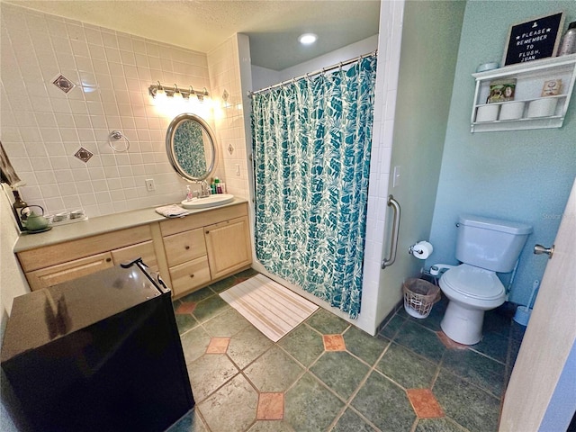 bathroom featuring vanity, curtained shower, and toilet