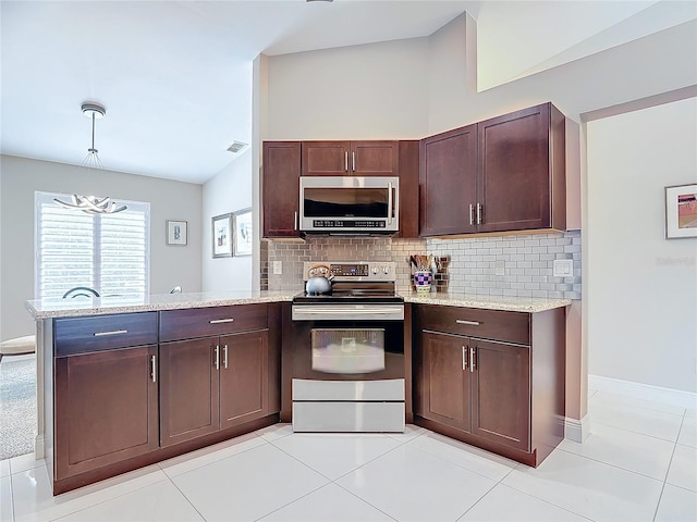 kitchen with kitchen peninsula, tasteful backsplash, stainless steel appliances, light tile patterned floors, and hanging light fixtures