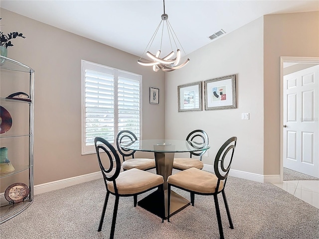 dining area featuring light carpet and a chandelier