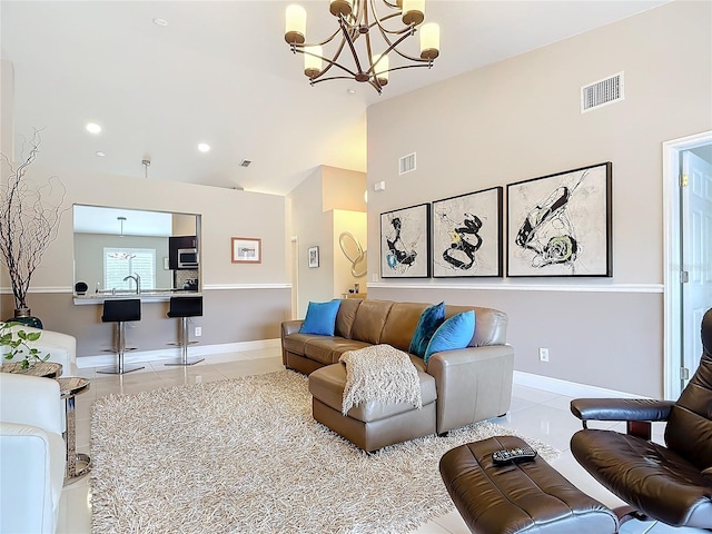 living room featuring tile patterned flooring, a notable chandelier, and sink