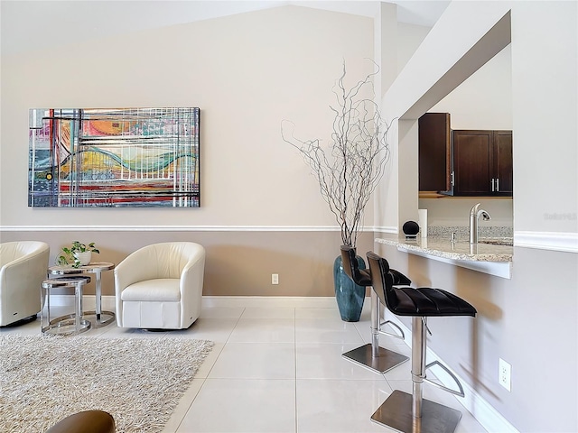 living area with sink and light tile patterned floors