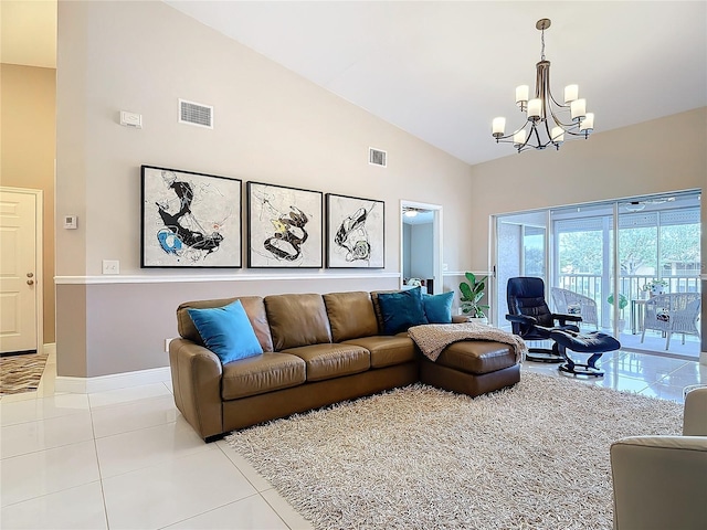 living room featuring light tile patterned floors, high vaulted ceiling, and a chandelier