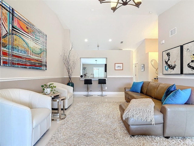 tiled living room featuring a chandelier