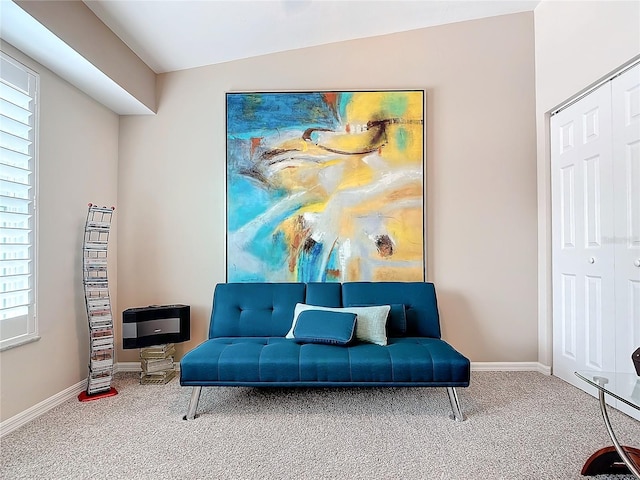 sitting room featuring a wealth of natural light, carpet, and vaulted ceiling