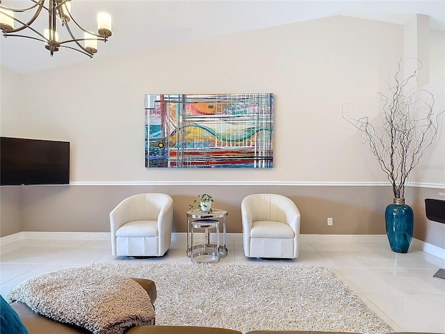 sitting room with tile patterned floors, vaulted ceiling, and an inviting chandelier