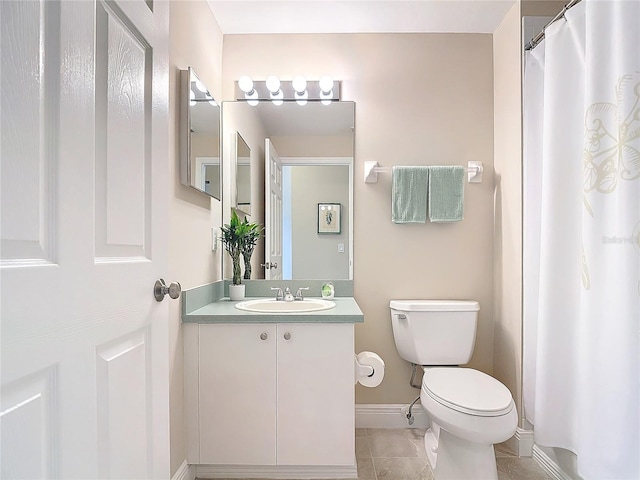 bathroom with tile patterned floors, vanity, and toilet