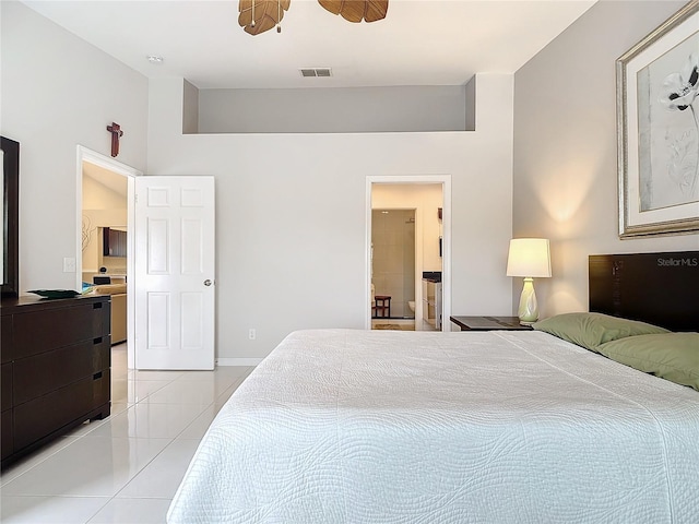 bedroom featuring ensuite bath, ceiling fan, and light tile patterned floors