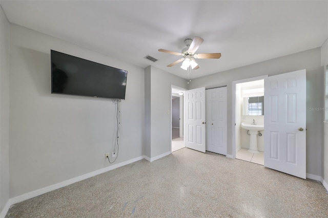 unfurnished bedroom featuring ceiling fan and ensuite bathroom