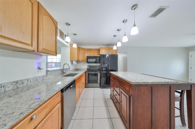 kitchen with a center island, decorative light fixtures, light tile patterned flooring, black appliances, and sink