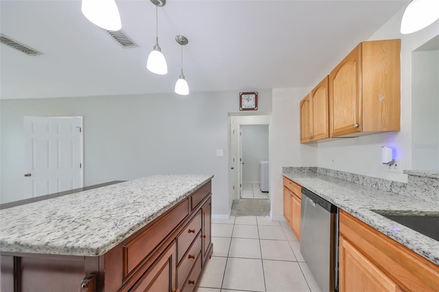 kitchen with light stone countertops, a center island, decorative light fixtures, light tile patterned flooring, and stainless steel dishwasher