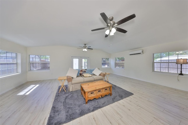 living room featuring light wood-style floors, a wall mounted AC, and plenty of natural light
