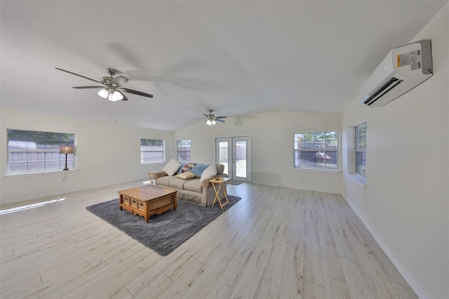 living area with vaulted ceiling, ceiling fan, light wood-style floors, and an AC wall unit