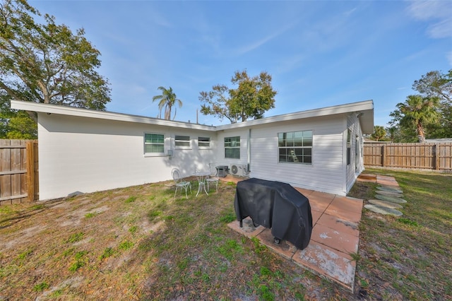 back of property featuring a fenced backyard