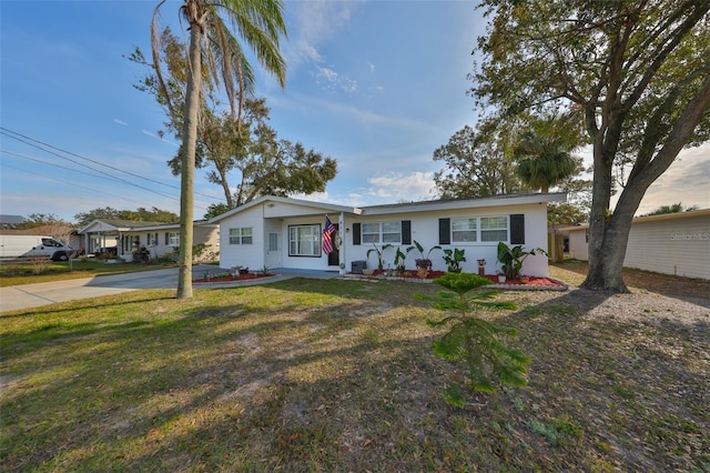 view of front of home featuring concrete driveway and a front yard