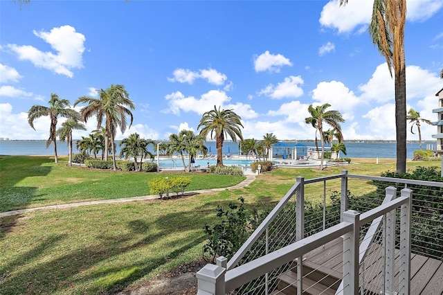 view of community with a yard and a water view