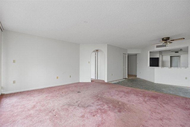 unfurnished living room featuring ceiling fan, carpet floors, and a textured ceiling