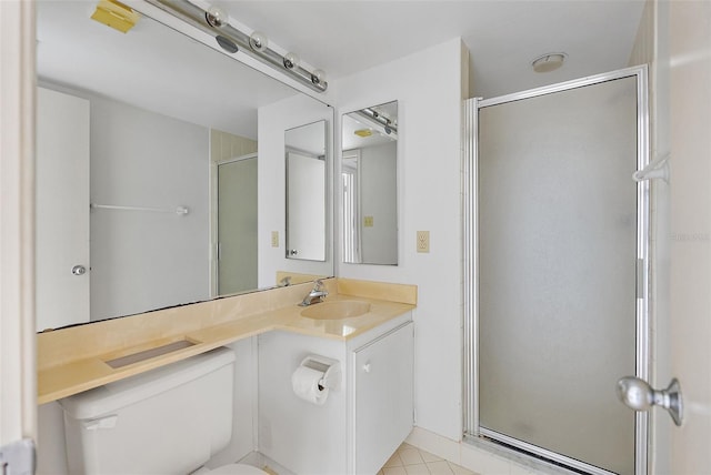 bathroom with tile patterned floors, vanity, toilet, and an enclosed shower