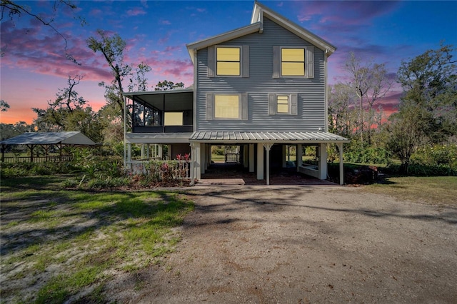 view of front facade featuring a sunroom and a carport