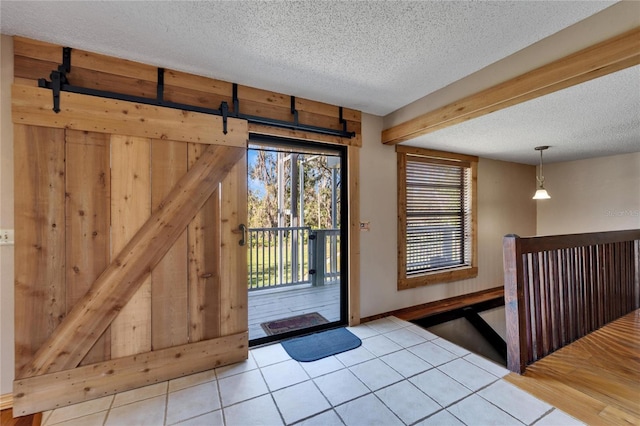 tiled entrance foyer with a textured ceiling