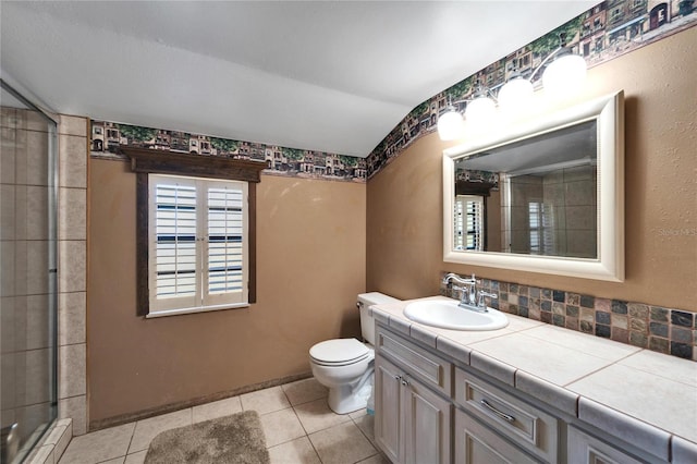 bathroom featuring toilet, vanity, tile patterned floors, and walk in shower