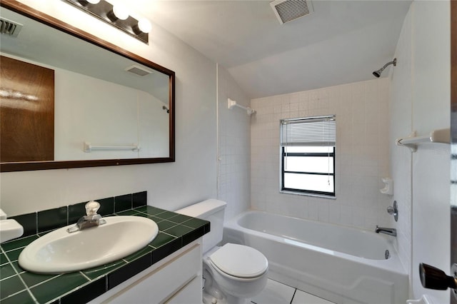 full bathroom featuring tile patterned flooring, vanity, toilet, and tiled shower / bath