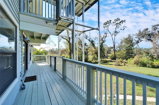 wooden terrace featuring a yard