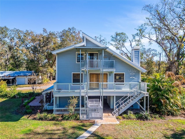 back of house featuring covered porch and a balcony