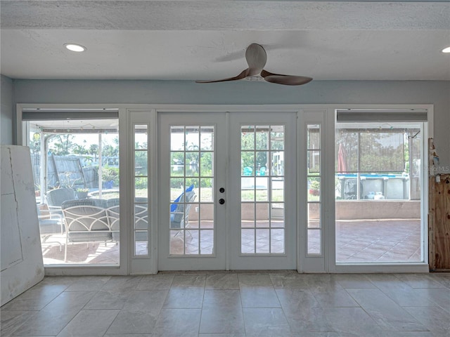 doorway to outside featuring french doors, a wealth of natural light, and ceiling fan