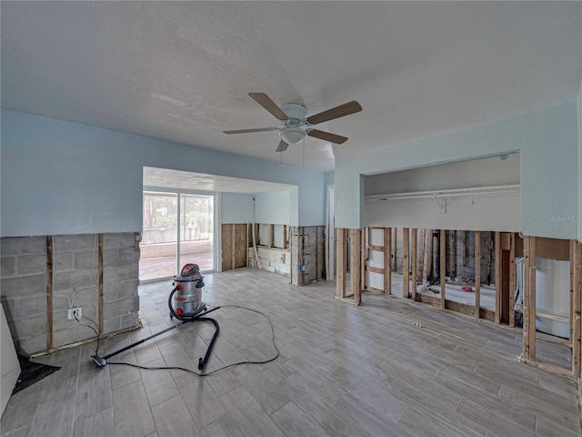 interior space featuring ceiling fan and a textured ceiling