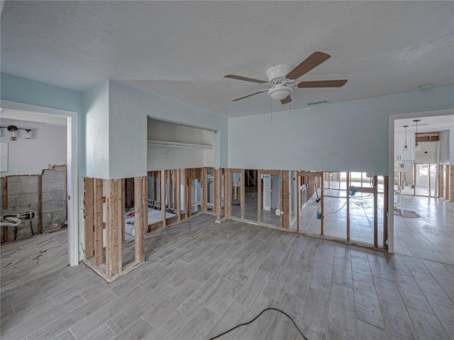 spare room with electric panel and ceiling fan