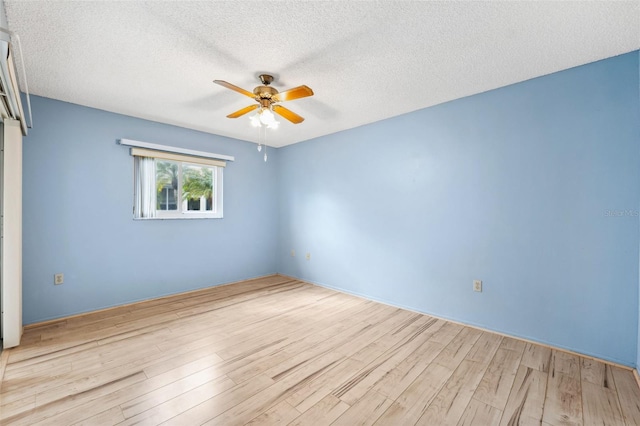 spare room with a textured ceiling, light hardwood / wood-style flooring, and ceiling fan