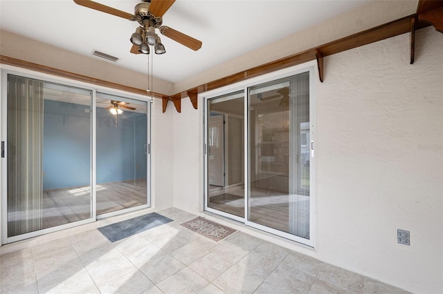 interior space with ceiling fan