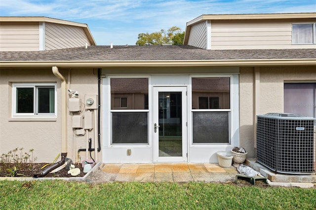 doorway to property featuring central air condition unit