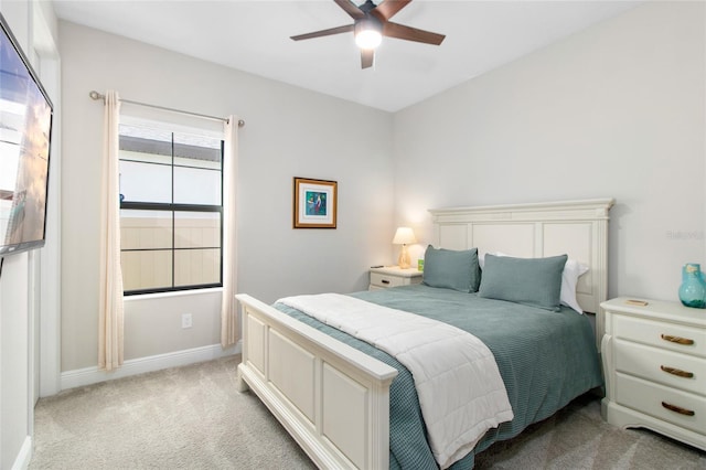 bedroom with ceiling fan and light carpet