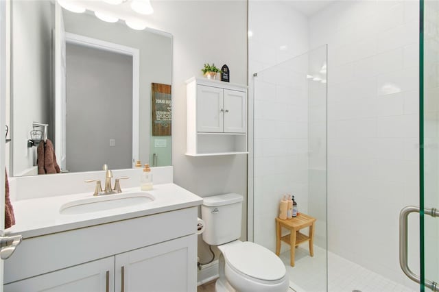 bathroom with an enclosed shower, vanity, and toilet