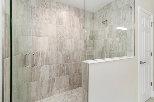 bathroom with a tile shower