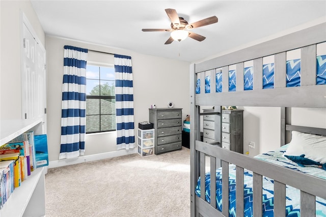 bedroom featuring ceiling fan, light colored carpet, and a closet