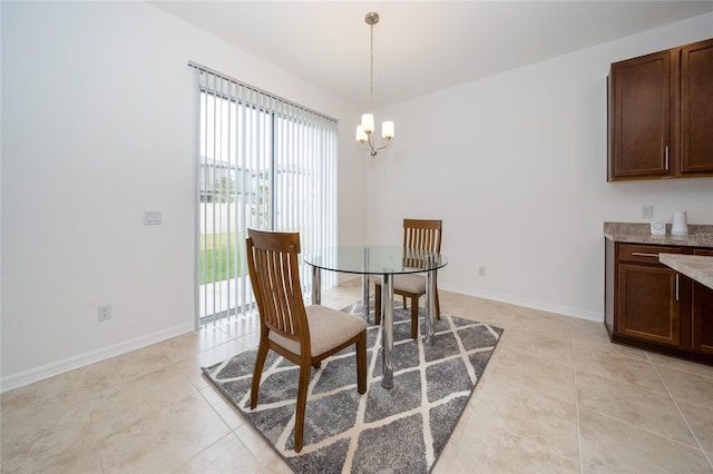 tiled dining room featuring a chandelier