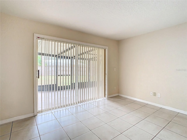 tiled spare room with a textured ceiling