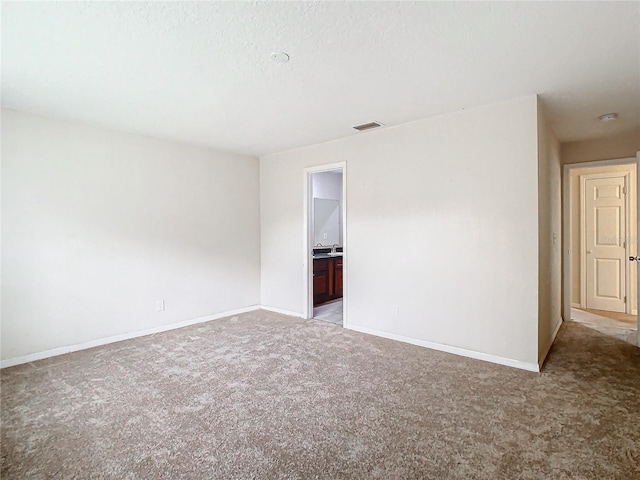 unfurnished room featuring light colored carpet