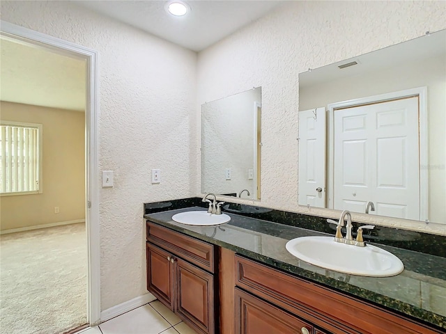 bathroom with tile patterned flooring and vanity