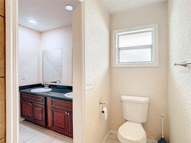 bathroom featuring tile patterned floors, vanity, and toilet