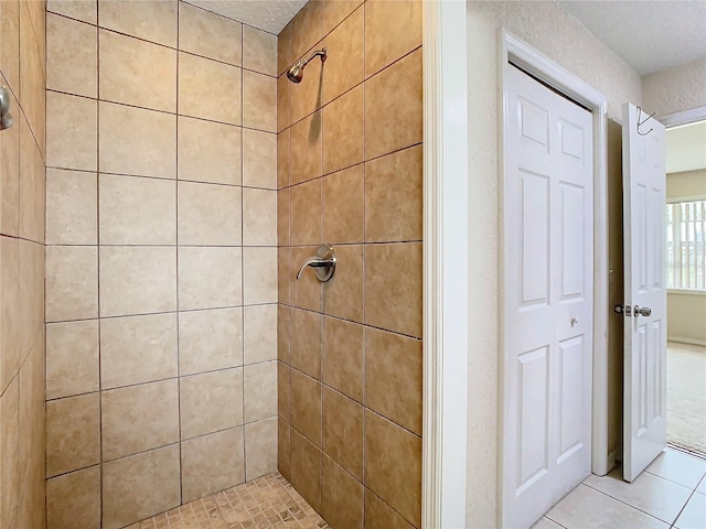 bathroom featuring a tile shower and tile patterned floors