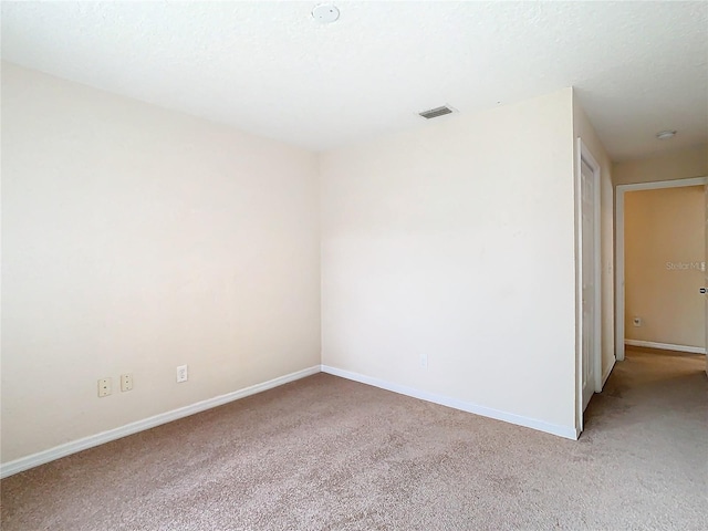 unfurnished room with light carpet