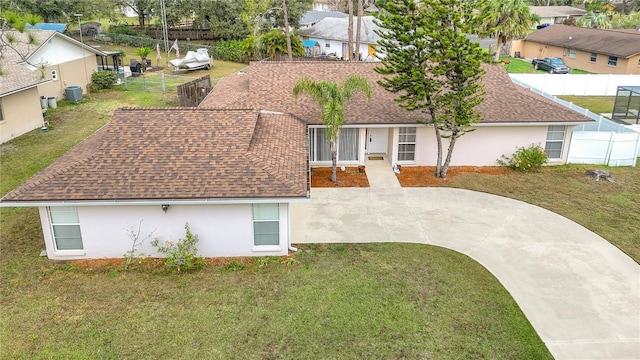 view of front of property featuring cooling unit and a front lawn