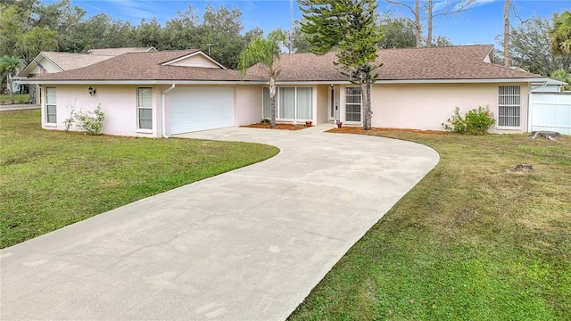 ranch-style home with a front lawn and a garage