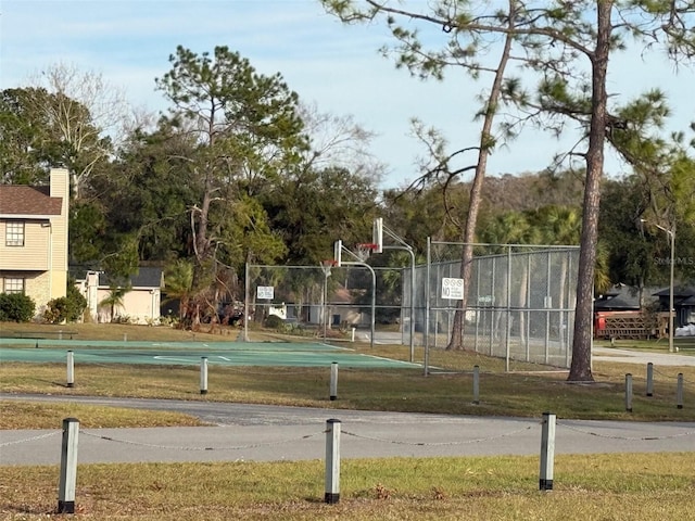 view of sport court featuring a yard